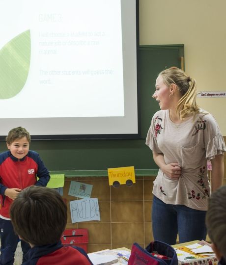 Teacher and student in front of the class presenting