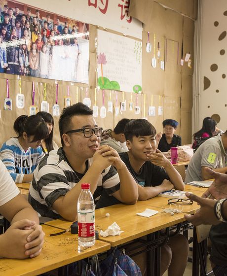 Teach in China teacher with his students in classroom