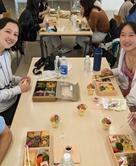 Young people eating sushi at a table in Japan