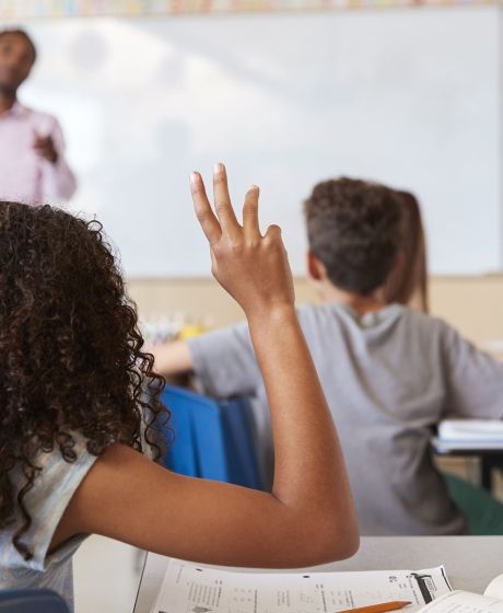 student raising her hand in class