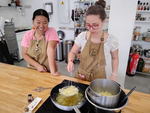 Gina removes potatoes from the oil