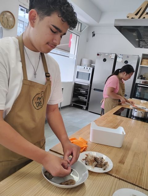 Student peels shrimp for paella