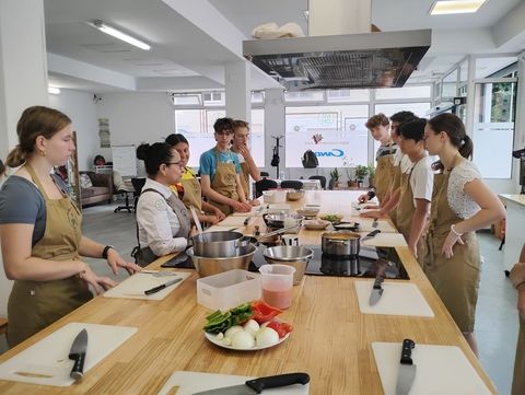 Students learning about paella ingredients