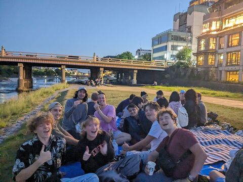 Gap year students having a picnic at night in Kyoto