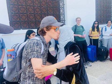 Participant greeting host family outside airport