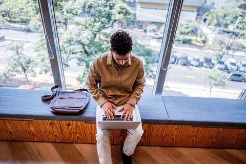 Young man on his laptop at university