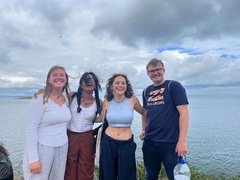 High school student group posing by the ocean