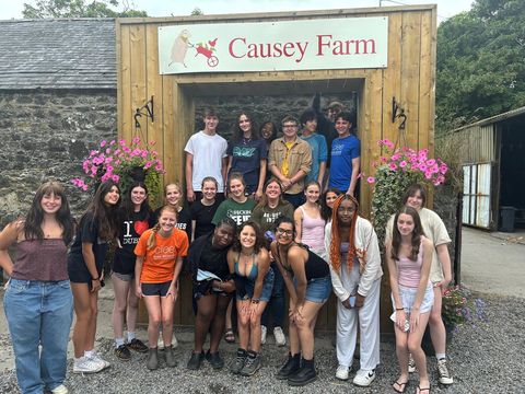 Group photo of high school participants in front of Causey Farm sign