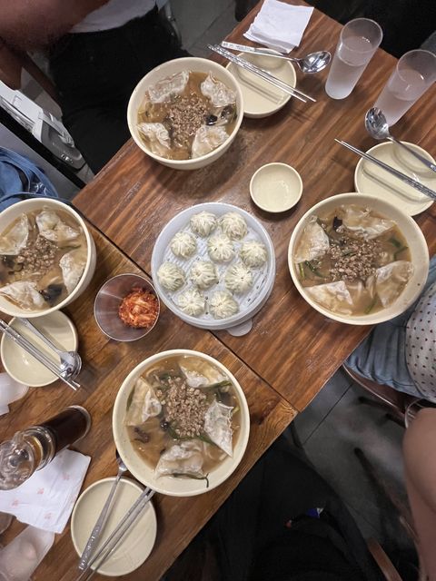 four bowls of noodle soup and dumplings