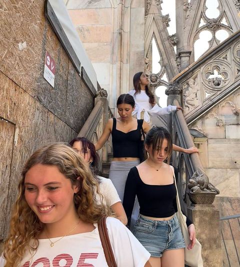 High school students walking down stairs on a historic building tour