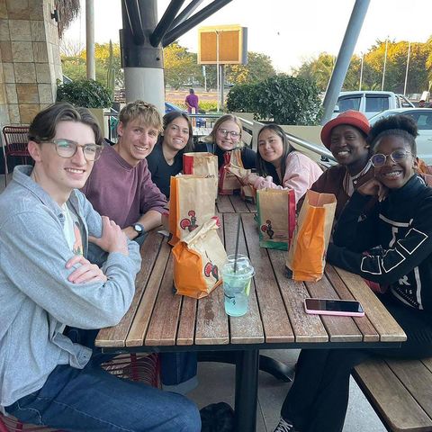 High school students on summer abroad program sharing a meal together