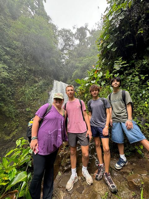 Students on program posing in front of waterfall after hike in Costa Rica