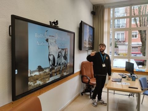 a person speaking and reading from the screen