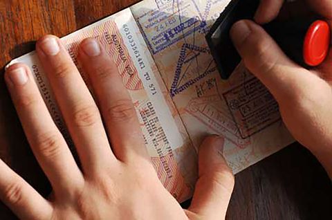 Person stamping a passport