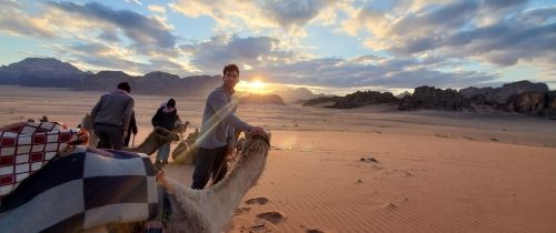 student with camel desert middle east