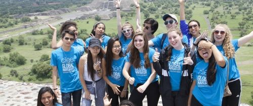 High schoolers wearing Global Navigators shirts smiling in Mexico