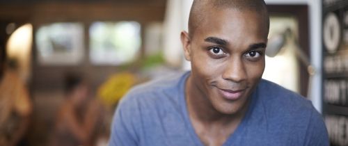 Young man smiling over laptop