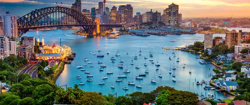 sydney harbor full of boats at sunset