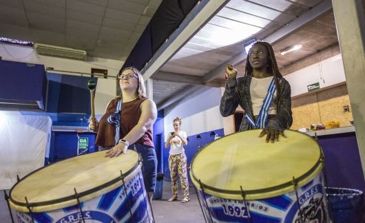 students abroad play drums in workshop