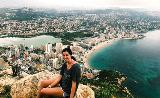 alicante girl on cliff above city