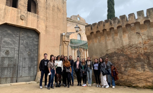 students visit castle wall barcelona spain