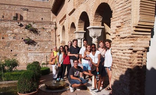 High school group posing under arch in Granada