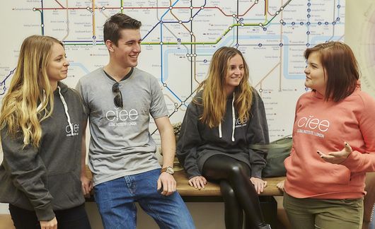 London students wearing CIEE shirts next a tube map