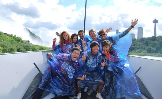 singapore students wearing ponchos on a boat