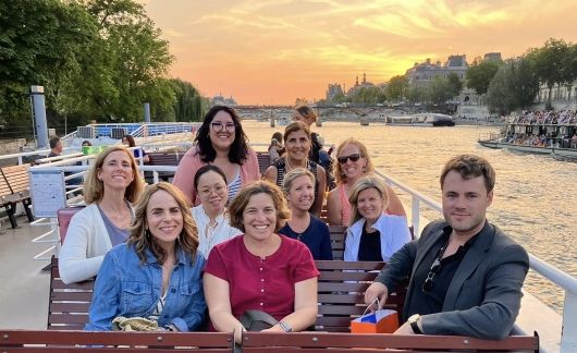 Group photo of adults on a boat on a river