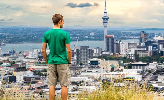 auckland man overlooking sky tower