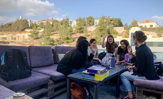 amman students playing board games at an outdoor cafe