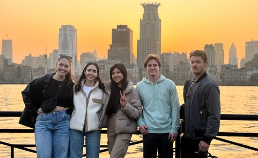 shanghai students in front of the city skyline