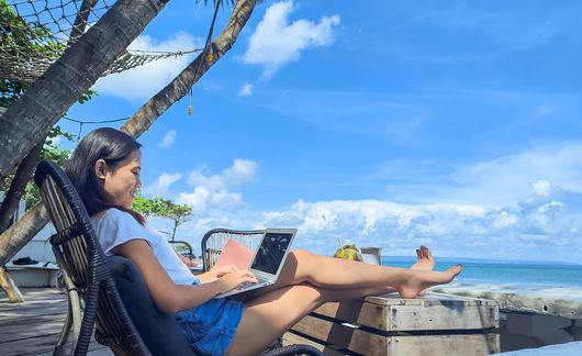 female-pax-on-laptop-seaside-cafe-with-a-beach-view.jpg