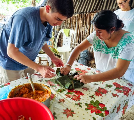 yucatan student learning to wrap food with banana leaves