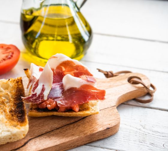 seville Breakfast of coffee with toast topped with olive oil and ham 