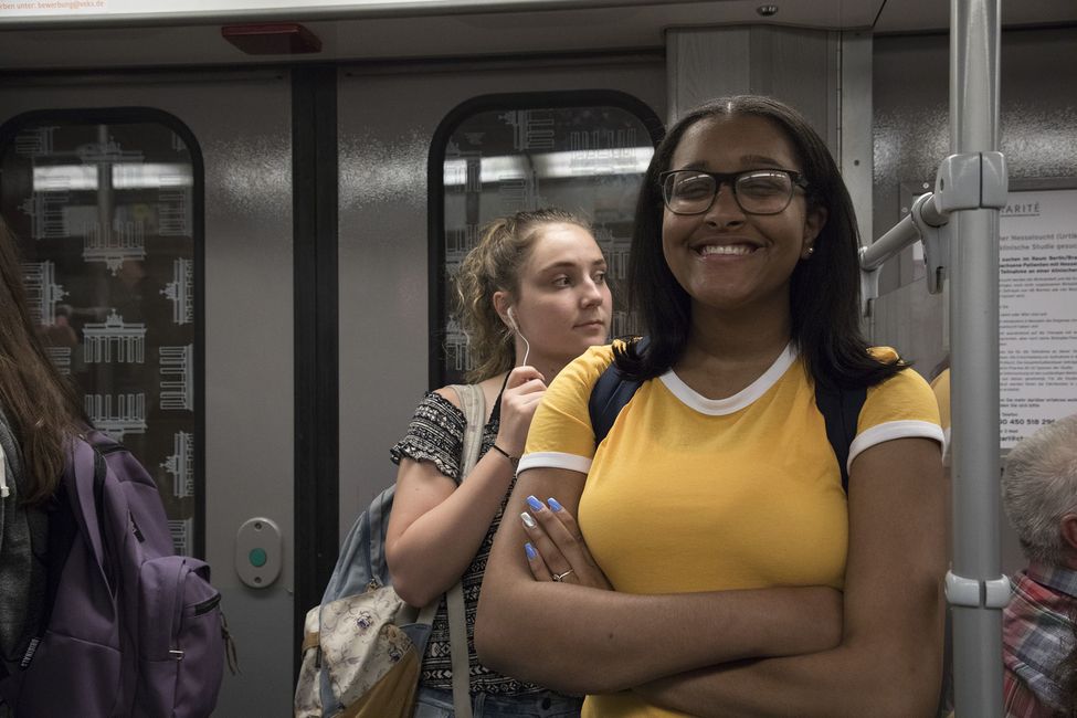 Student on the metro in Berlin smiling