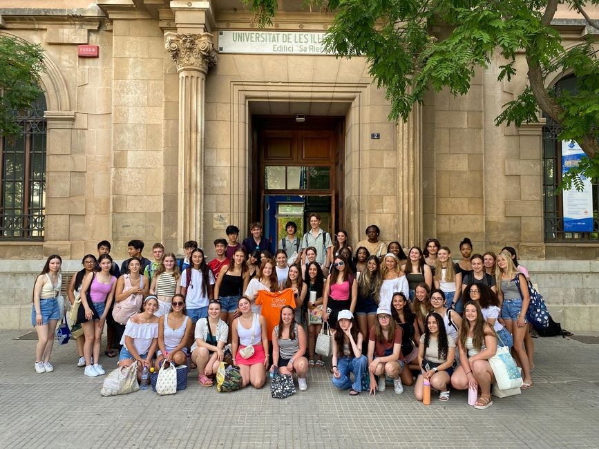 group photo of students in front of campus