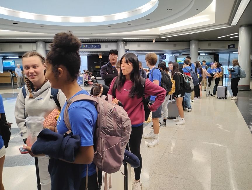 students waiting in line at the airport