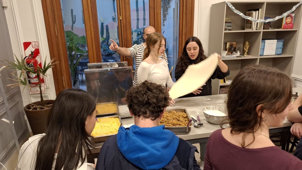 Lili and Natalie stretch out the dough.