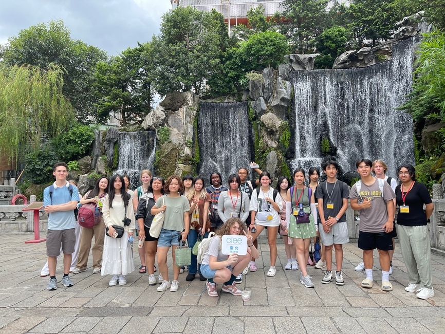 A group of students in front of a waterfall at longshan temple
