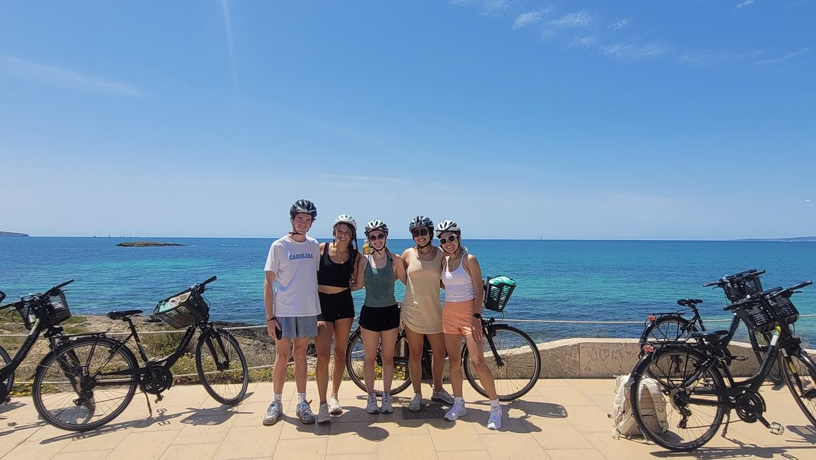 Students biking in Palma de Mallorca by the beach