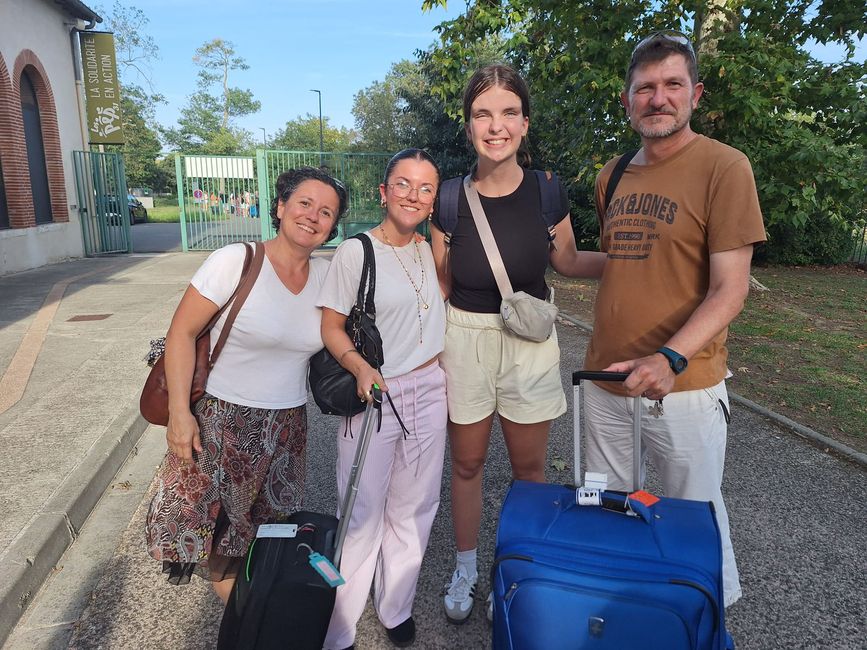 High school semester abroad student with host family and luggage