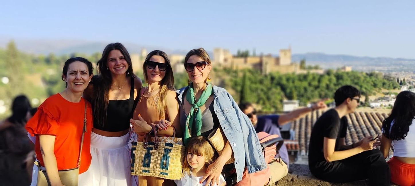 Host family and student with host siblings posing with castle in the background