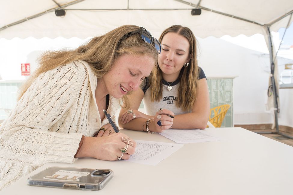 Students writing in café