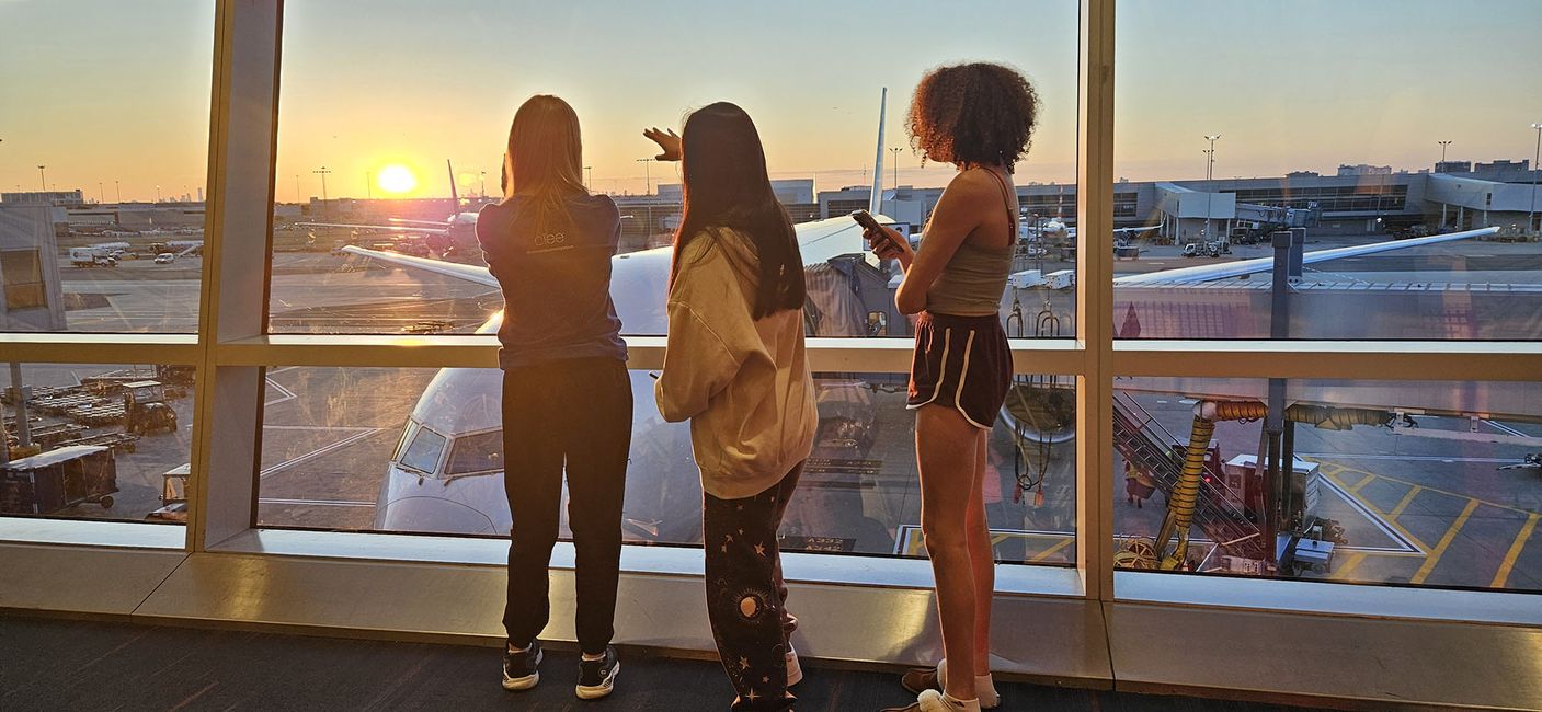 Teenagers watching the sunset from the airport