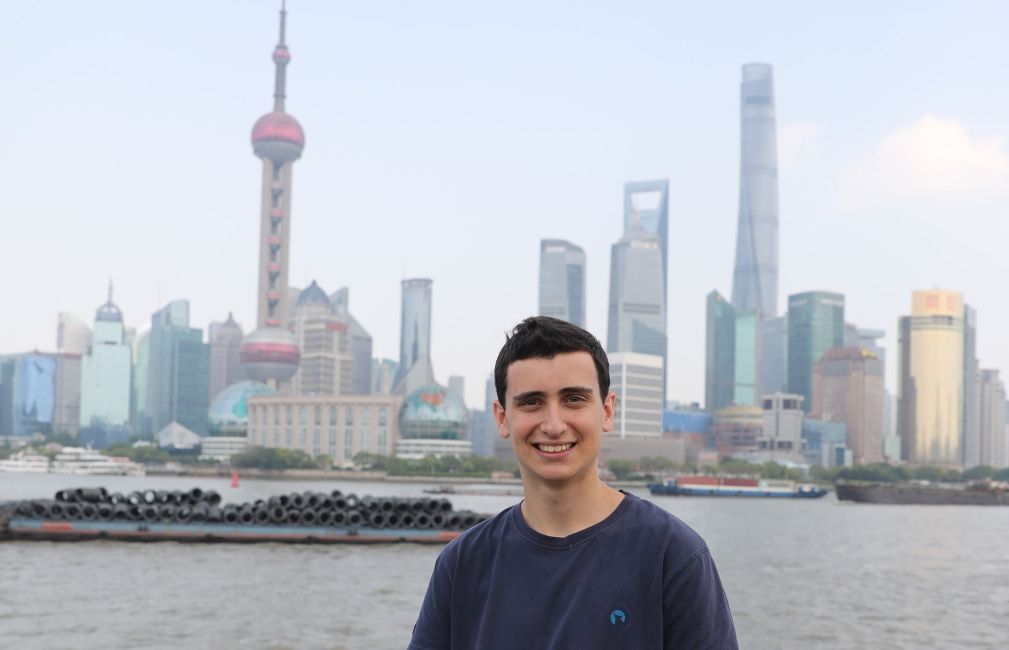 boy in shanghai with city in back