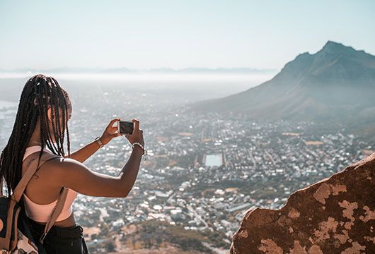 cape town girl taking photo of city skyline