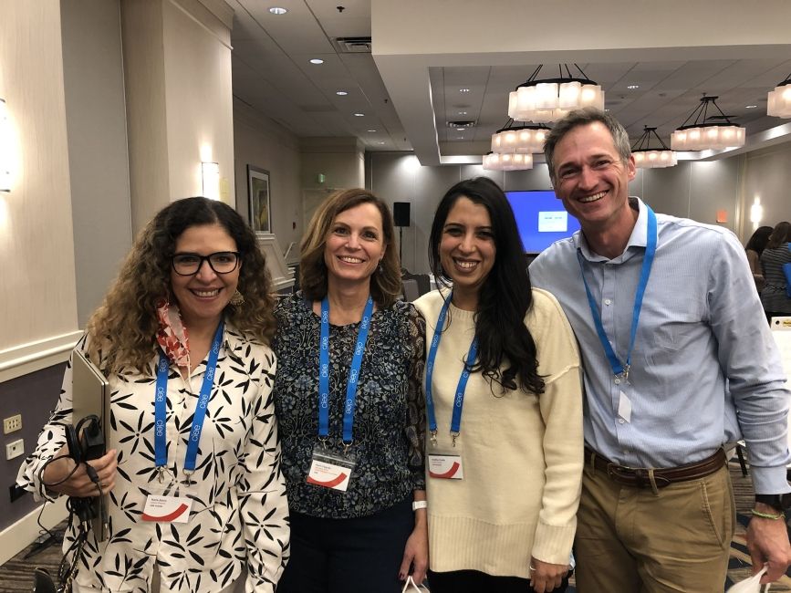 Group of CIEE employees posing at a symposium