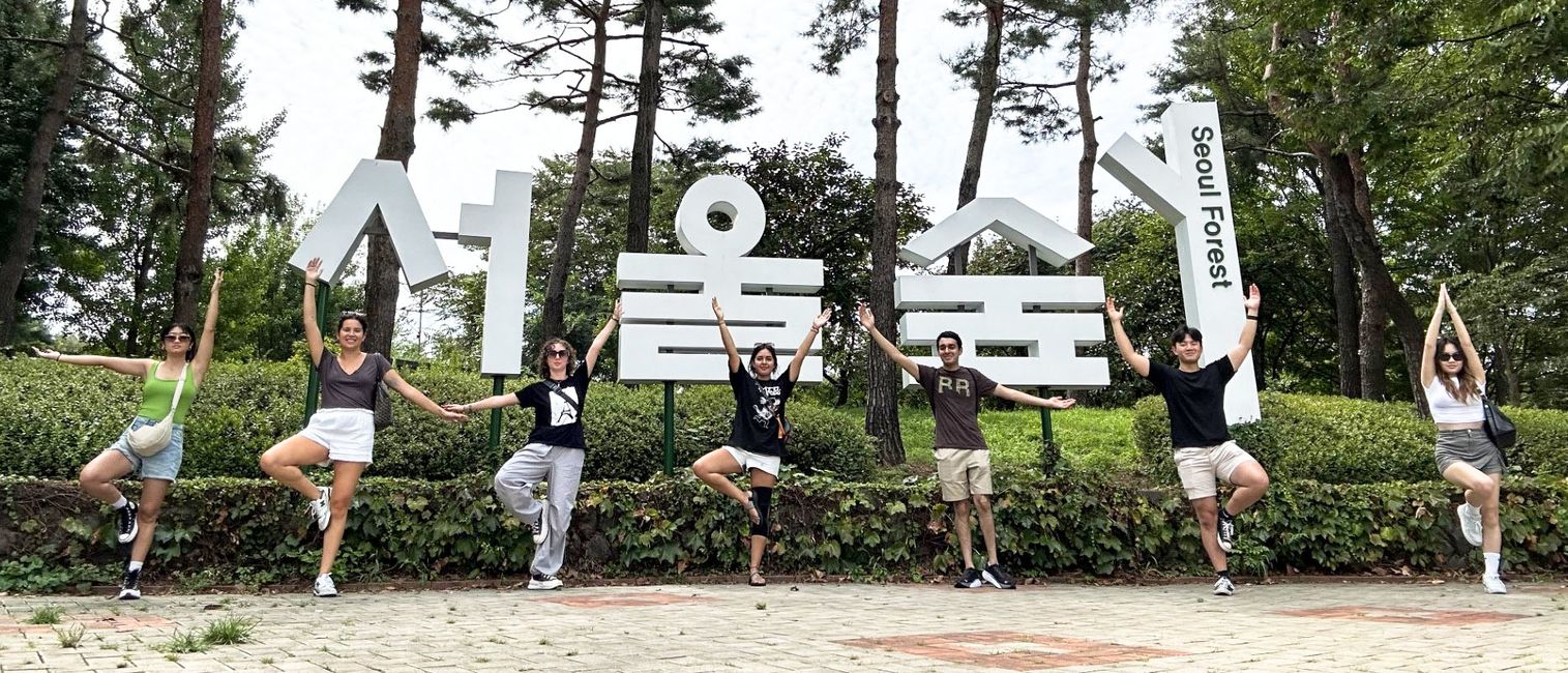 seoul students posing next to seoul forest sign