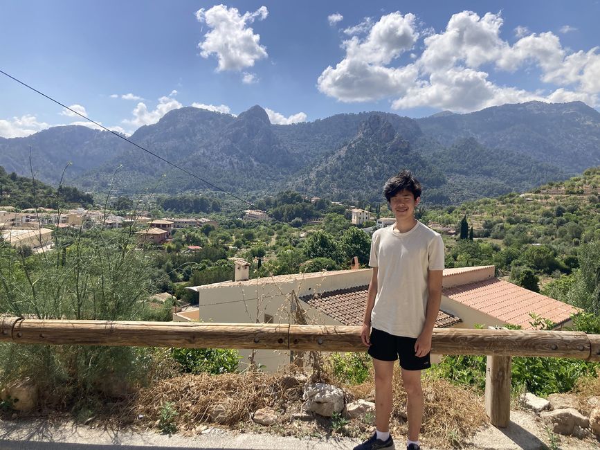 High school student posing in front of a scenic mountain abroad